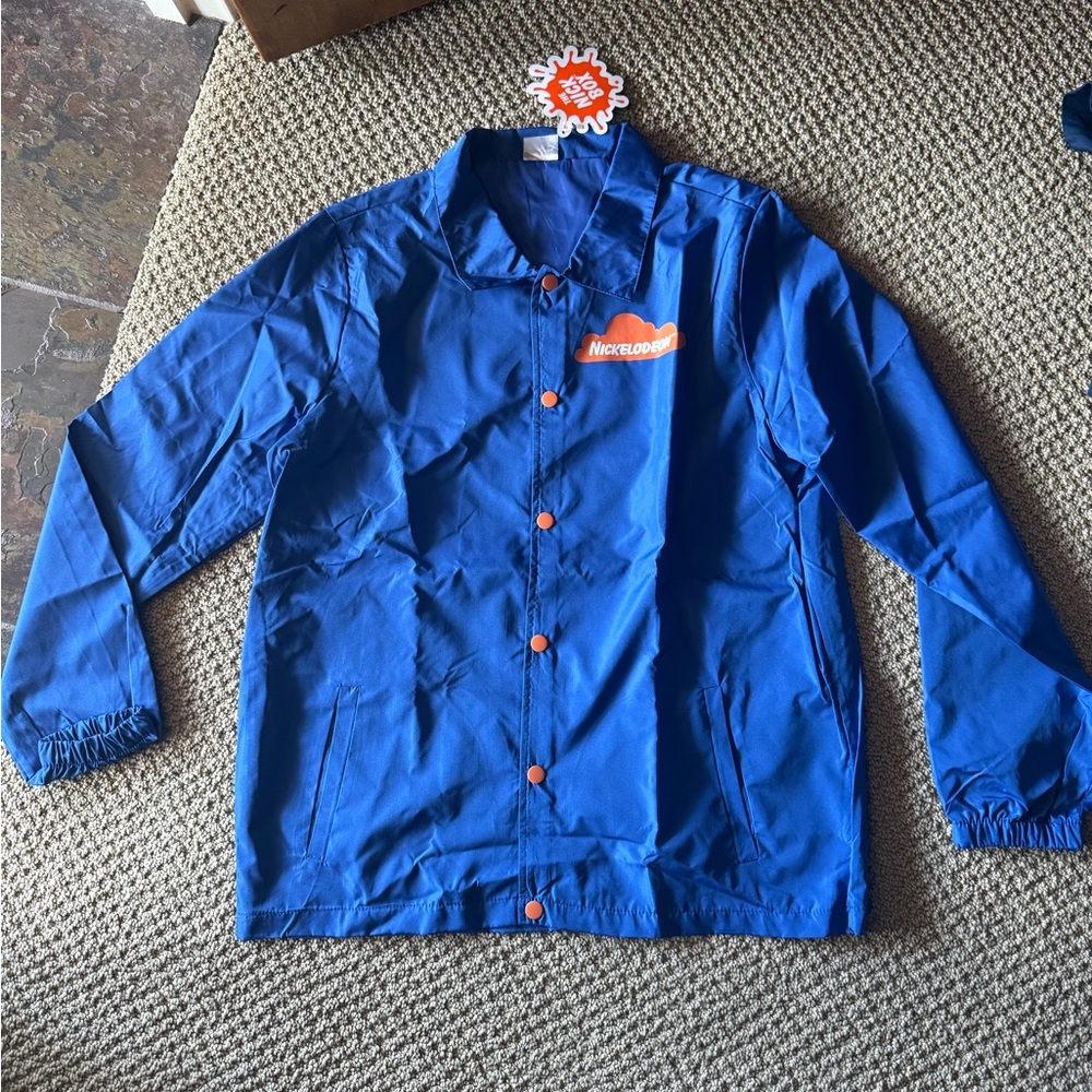 NWT Nickelodeon Blue Windbreaker jacket with orange buttons Nick Box exclusive